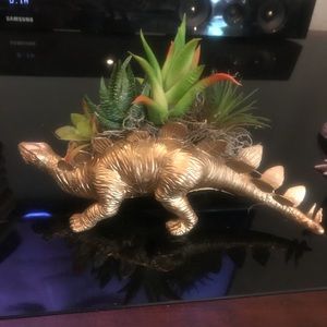 Gold Dinosaur with artificial succulent.